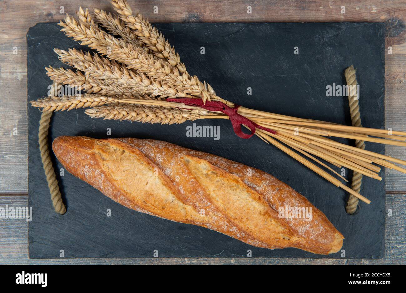 Baguette or a French bread and some wheat ears Stock Photo - Alamy