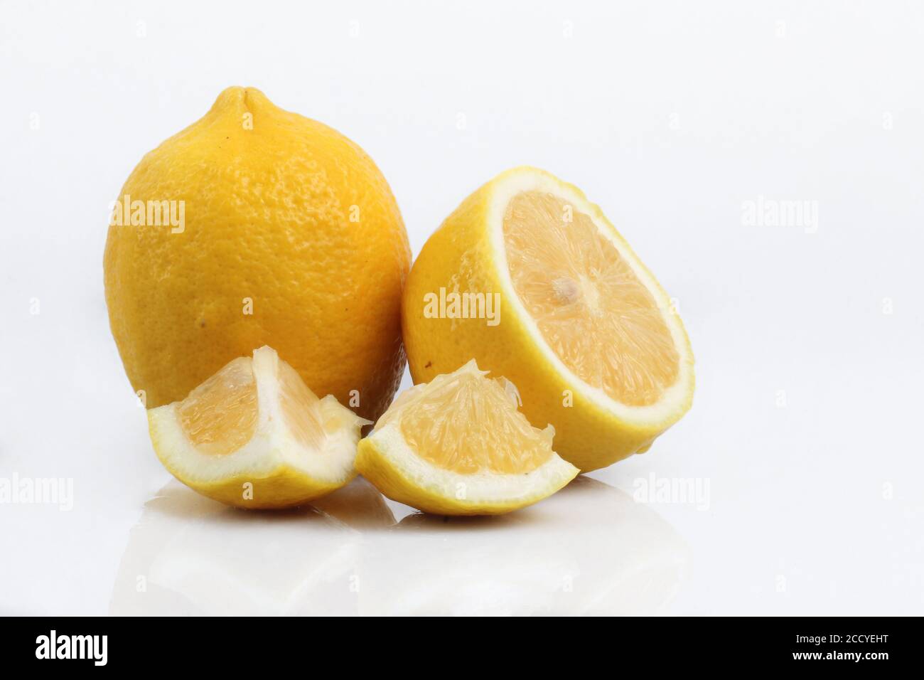 Lemon, sliced and cut on white plastic acrylic Stock Photo - Alamy