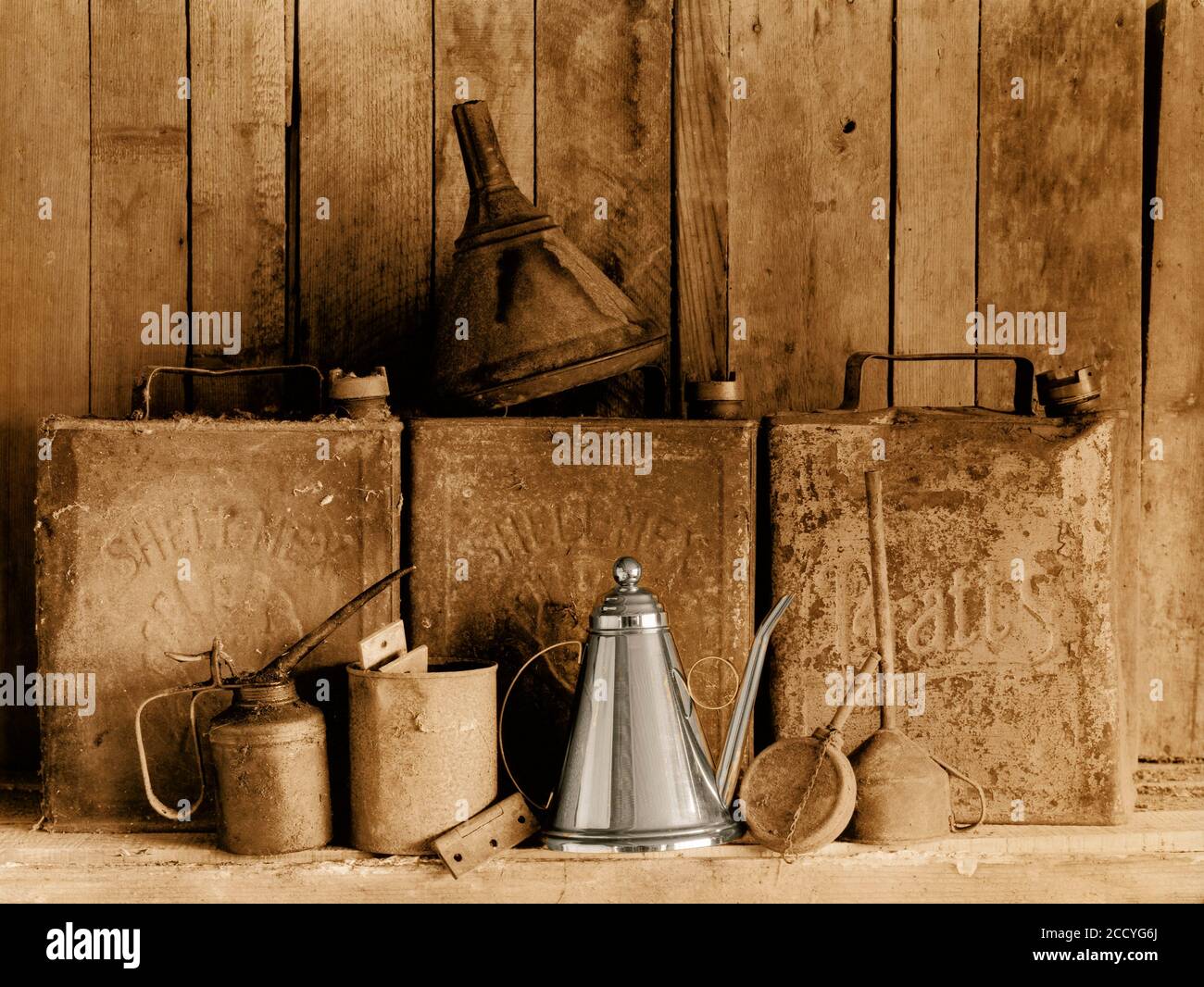 Still Life. Old motor oil cans on wooden shelves. Stock Photo