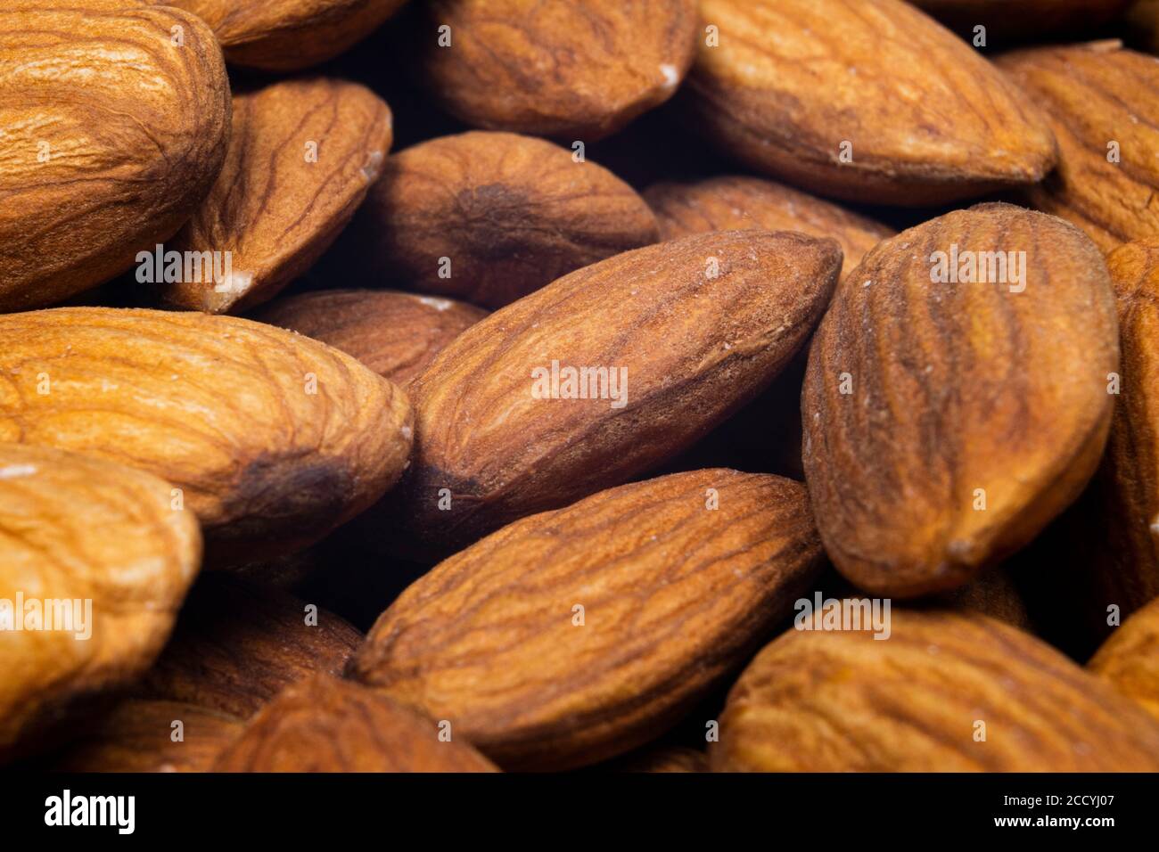 Almond background close up. Macro shot fresh almonds nuts background