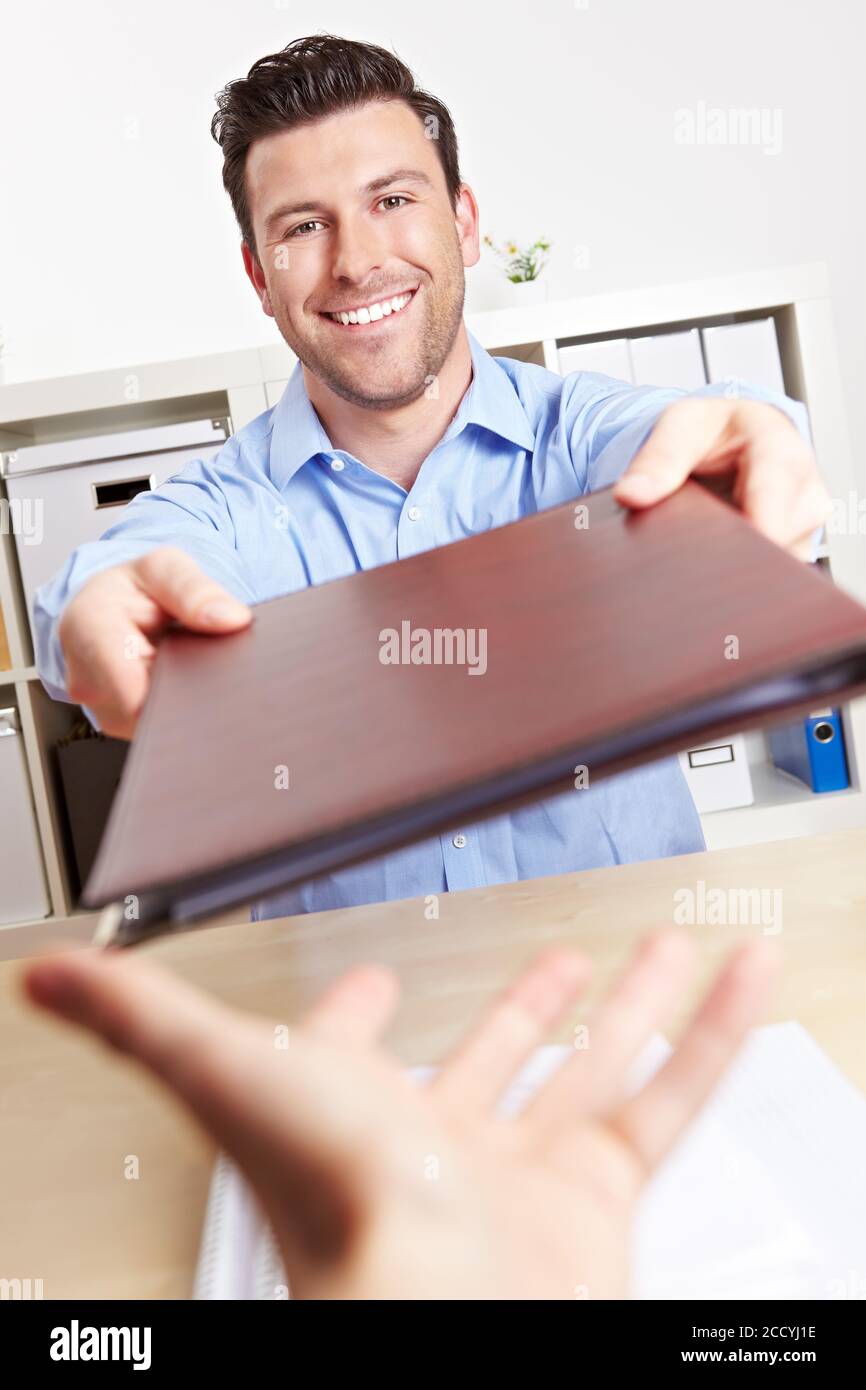 Trainee with his application folder in the office Stock Photo