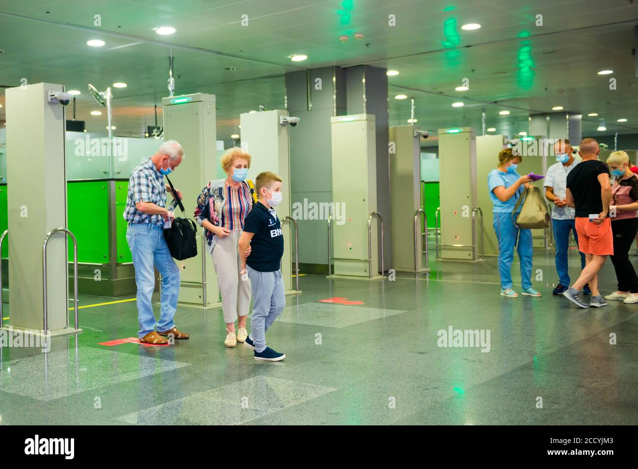 Kiev, Ukraine tourists in face masks after crossing borderline in international airport Stock Photo