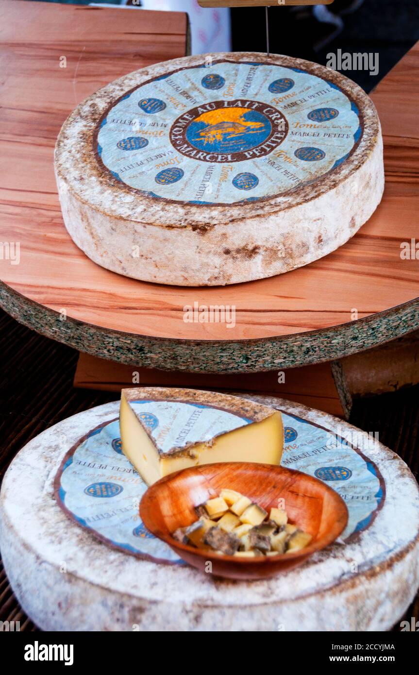 Cheese wheels and samples at the farmer's market in Figueres, Spain