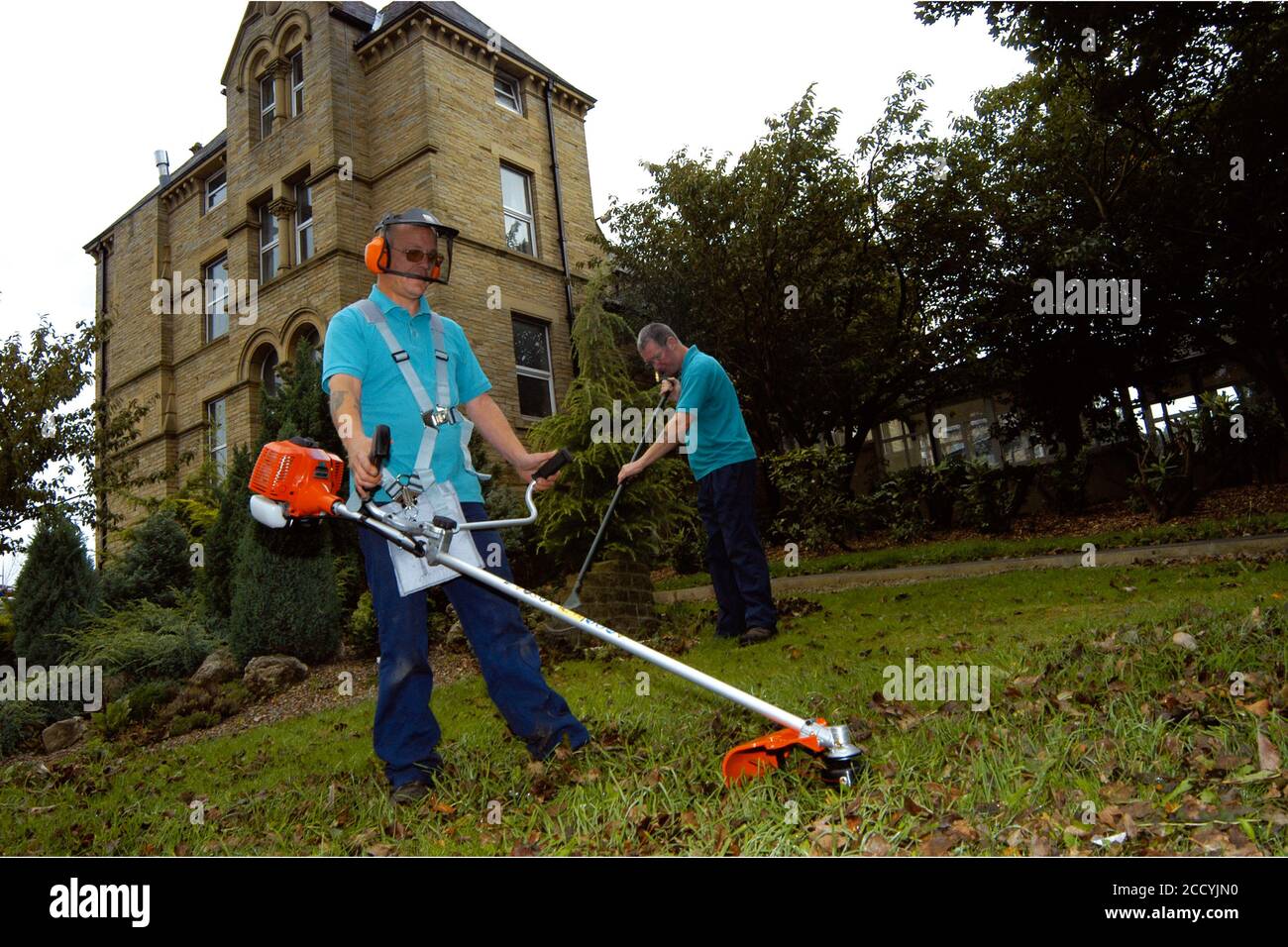 Grass strimming grounds maintenance at NHS hospital Yorkshire UK Stock