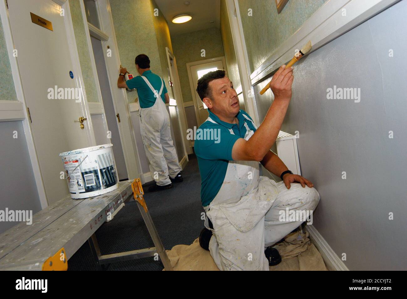 Painters & decorators painting old NHS building Yorkshire UK Stock Photo