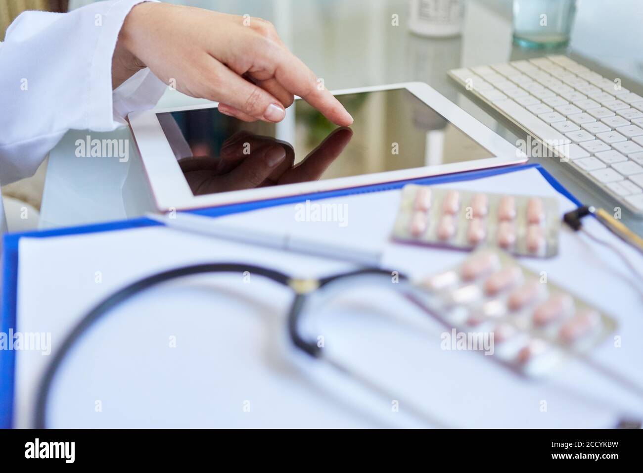 Doctor does research on the tablet computer for a drug in the clinic Stock Photo