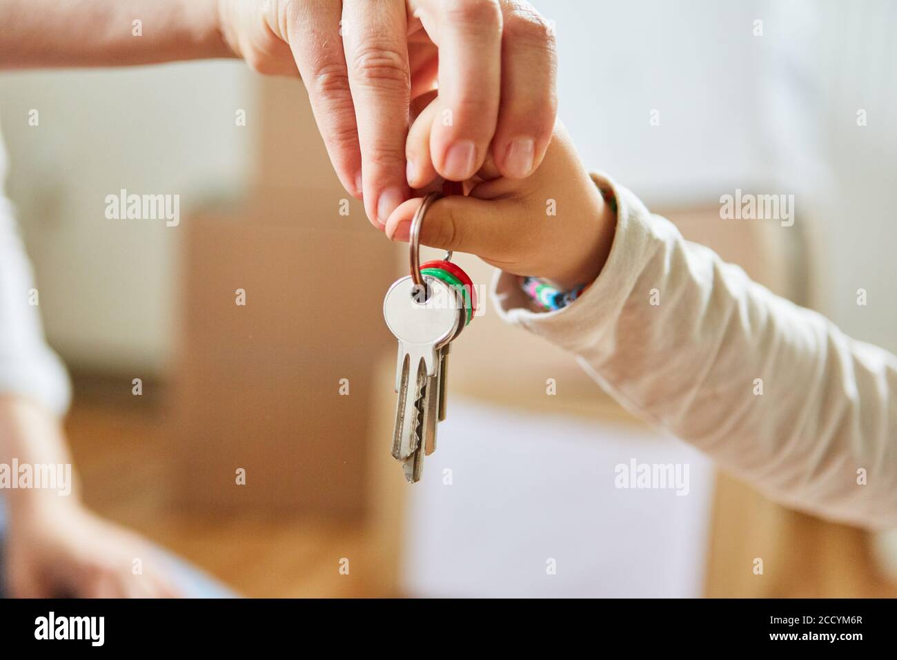 Father and son hold the key to their new home together Stock Photo