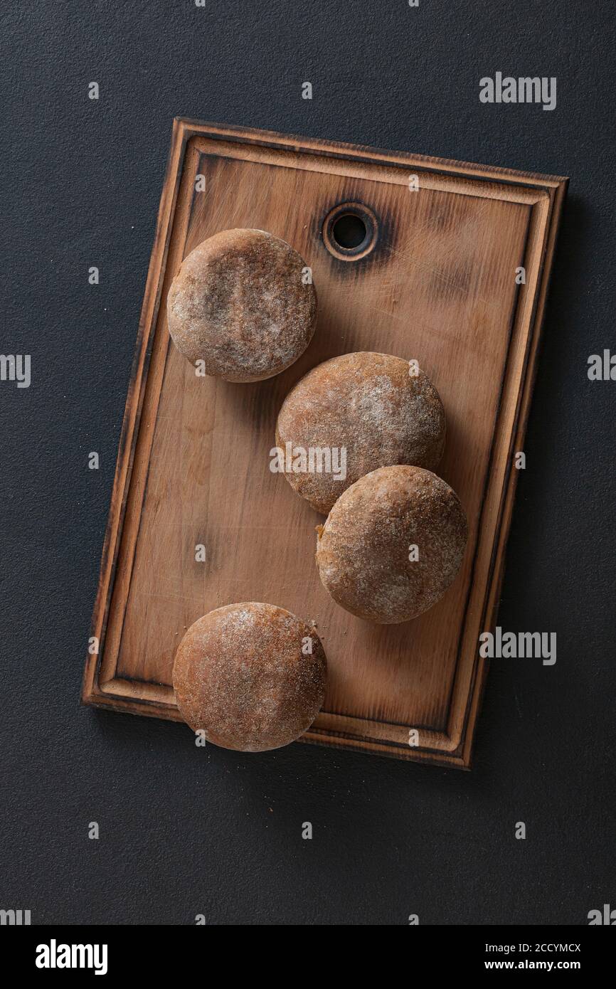Italian buns on kitchen board top view. Stock Photo