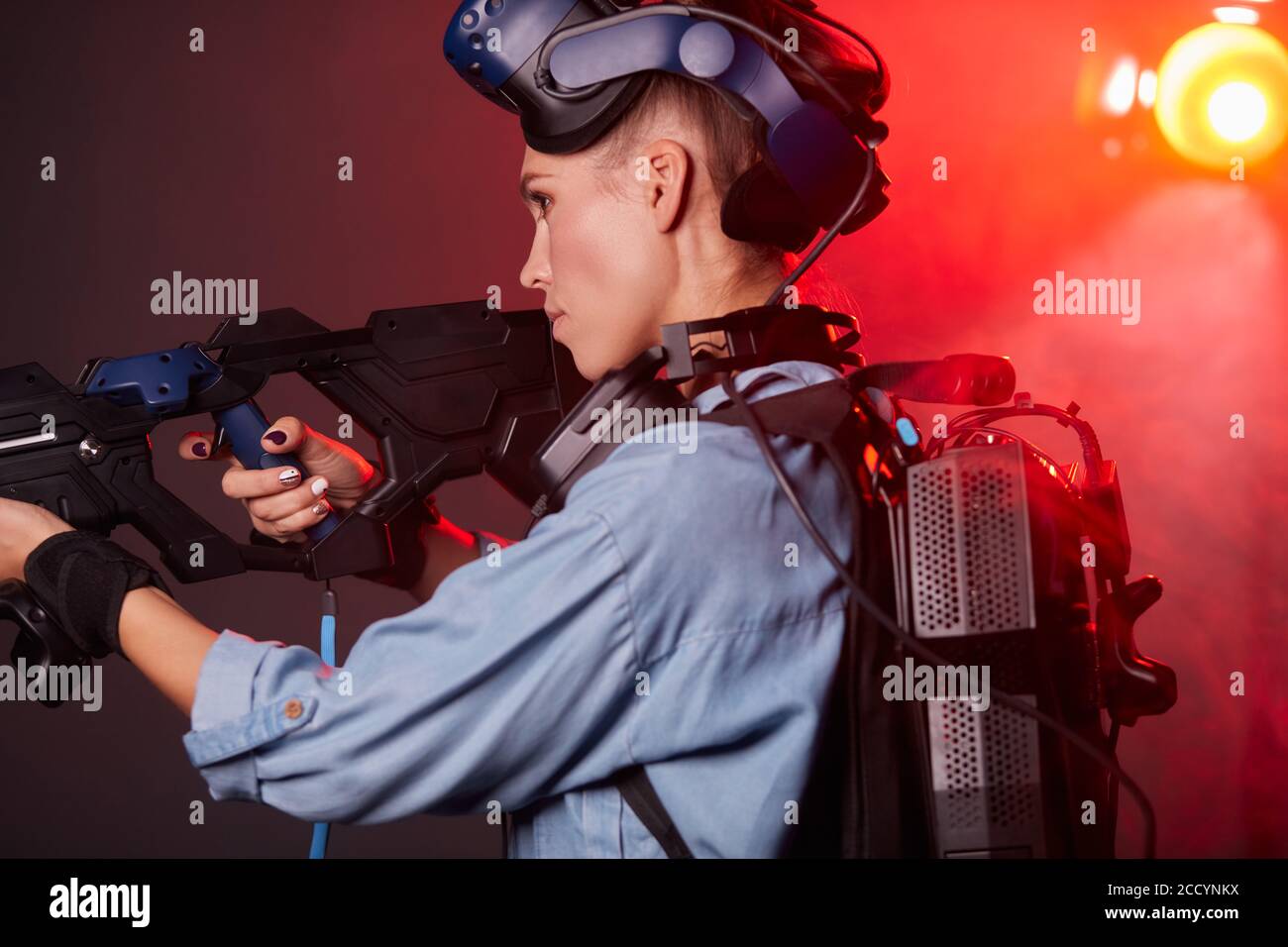 VR female gamer use modern technology, virtual reality game with guns