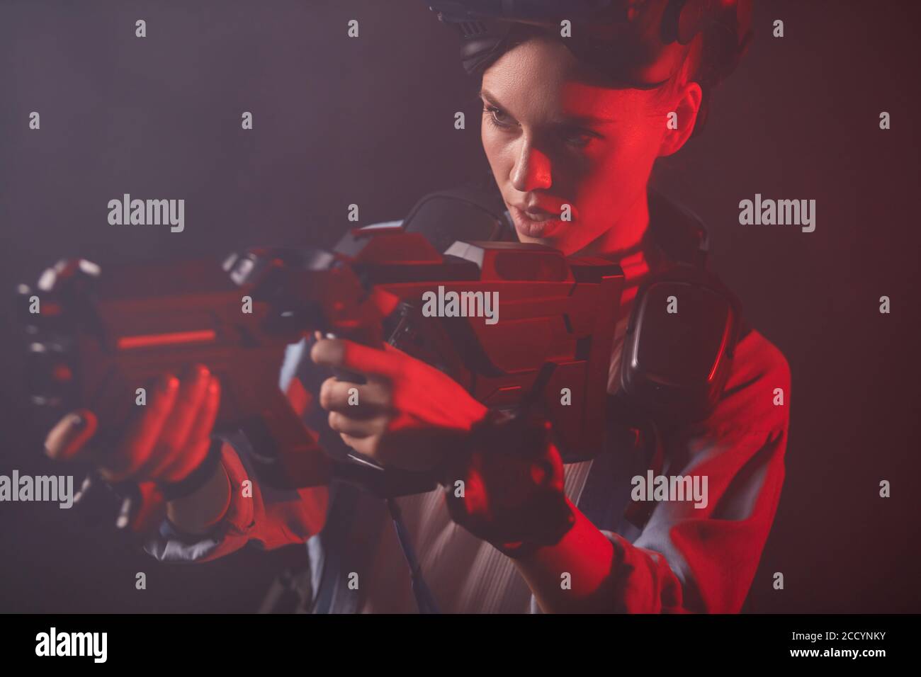 Shooting games, woman in special clothes wearing equipment, headsets and vr weapon