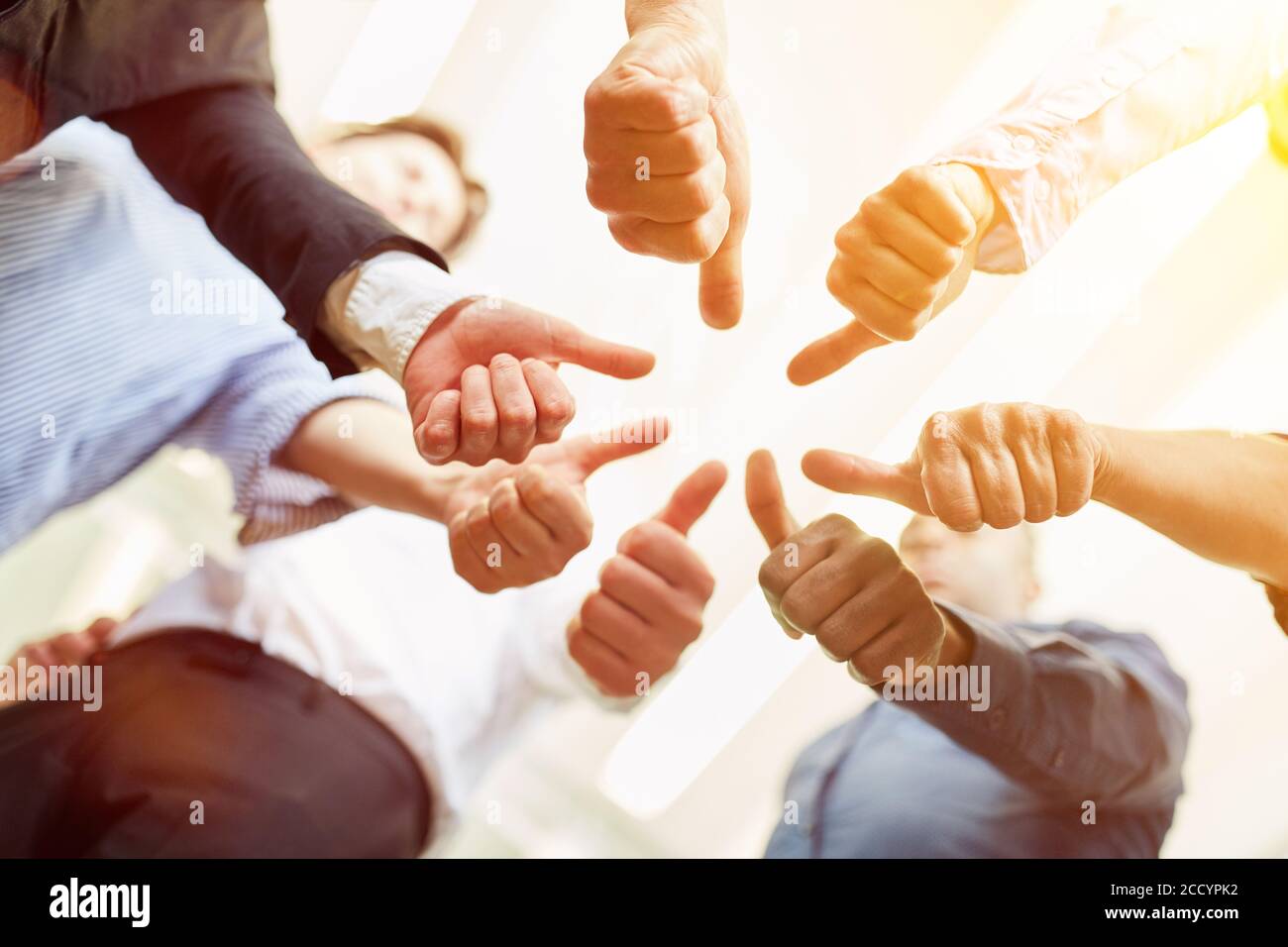 Business team holding many thumbs up together as a collaboration and network concept Stock Photo