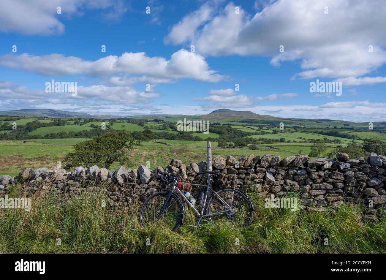 Summer cycling in the Yorkshire Dales with Ingleborough in the background. Stock Photo