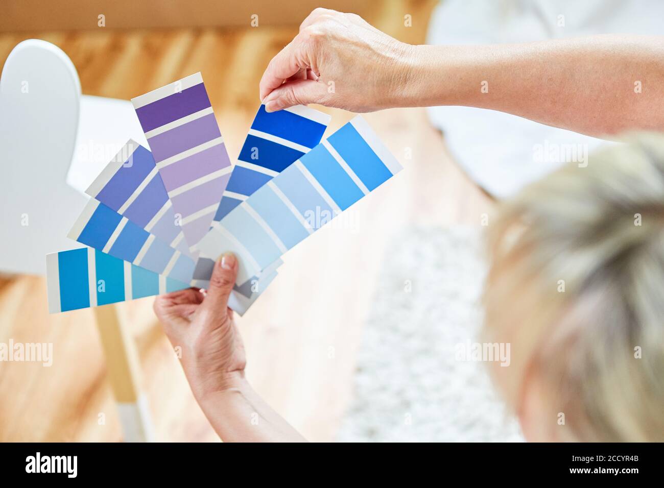 Hands hold color palette for color selection when renovating new ...