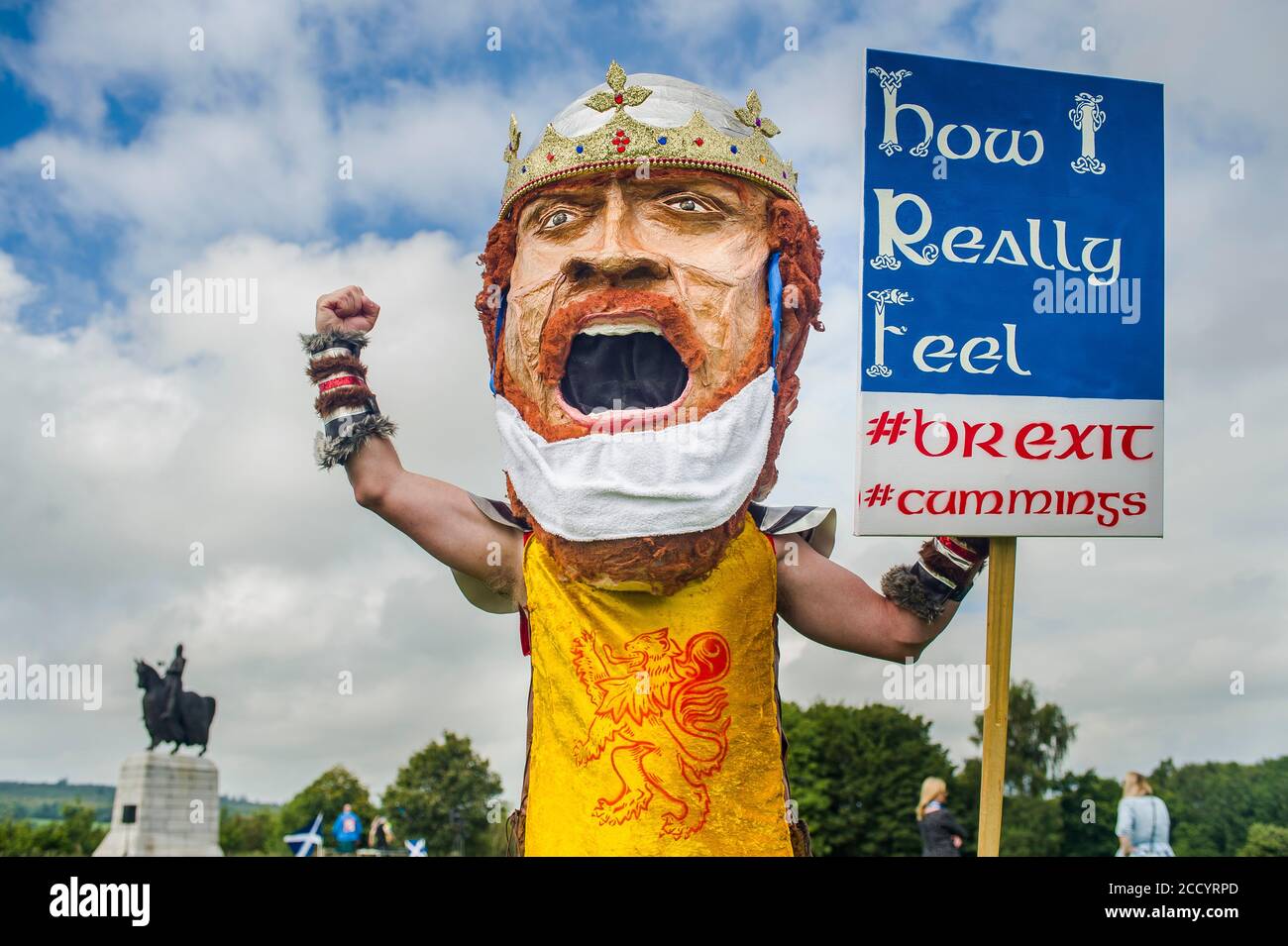 Artist Ariel Killiek's paper mache of King Robert the Bruce attends all under one banner hold a socially distanced protest about land reform at Bannockburn, by King Robert the Bruce statue.  Credit: Euan Cherry Stock Photo