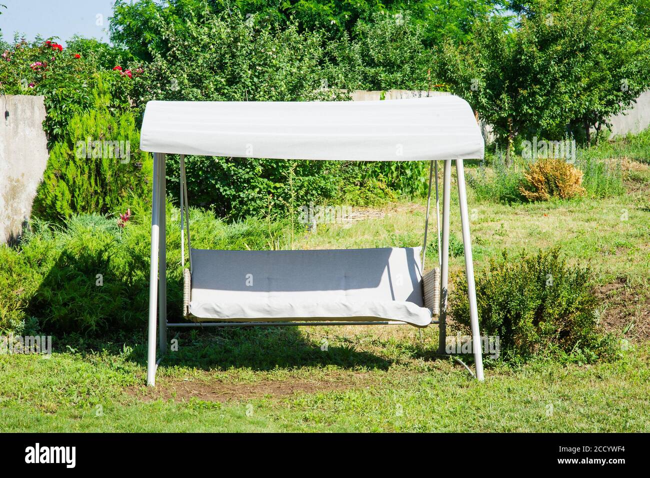 Garden. Garden furniture swing. Rest area near the house. Rest and relaxation concept. Stock Photo