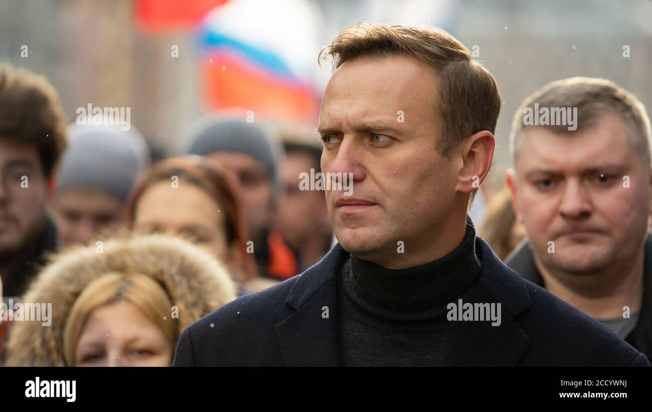 MOSCOW, RUSSIA - 29 FEBRUARY 2020, Aleksey Navalny and his wife Julia Navalnaya on the Nemtsov Memory march. Russian flags are on the background. Stock Photo