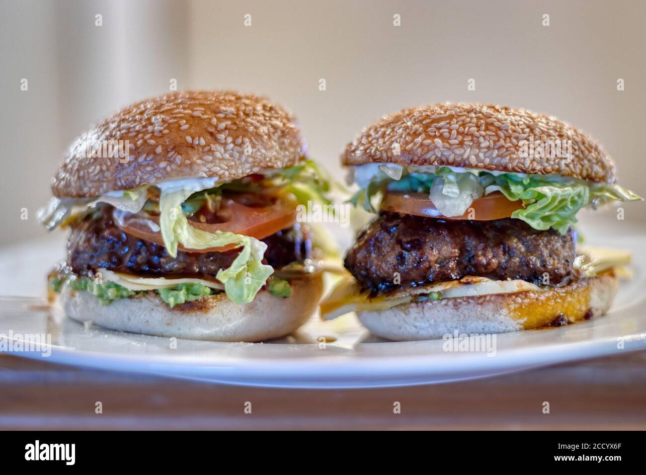 Juicy Beef Hamburger on a Plate, Perfectly Cooked to Satisfy Your Hearty Appetite with Fresh and Tasty Flavors Stock Photo