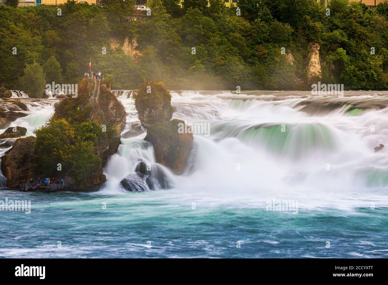 The Rhine Falls (German: Rheinfall) is the largest waterfall in Switzerland and Europe. The falls are located on the High Rhine on the border between Stock Photo