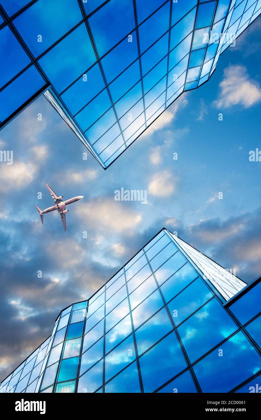 airplane flying between buildings Stock Photo Alamy
