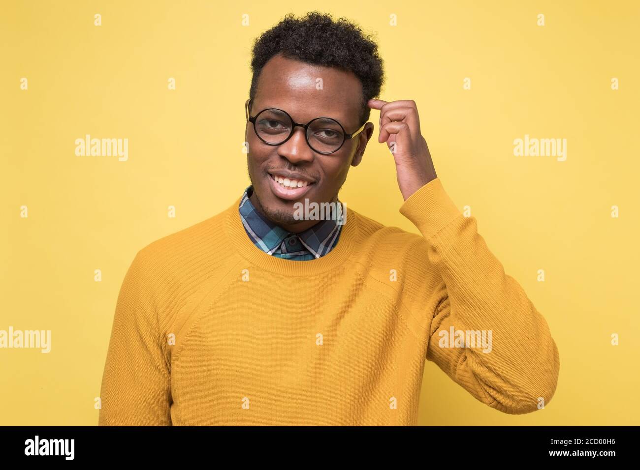 Handsome young african man wearing glasses smiling. Stock Photo