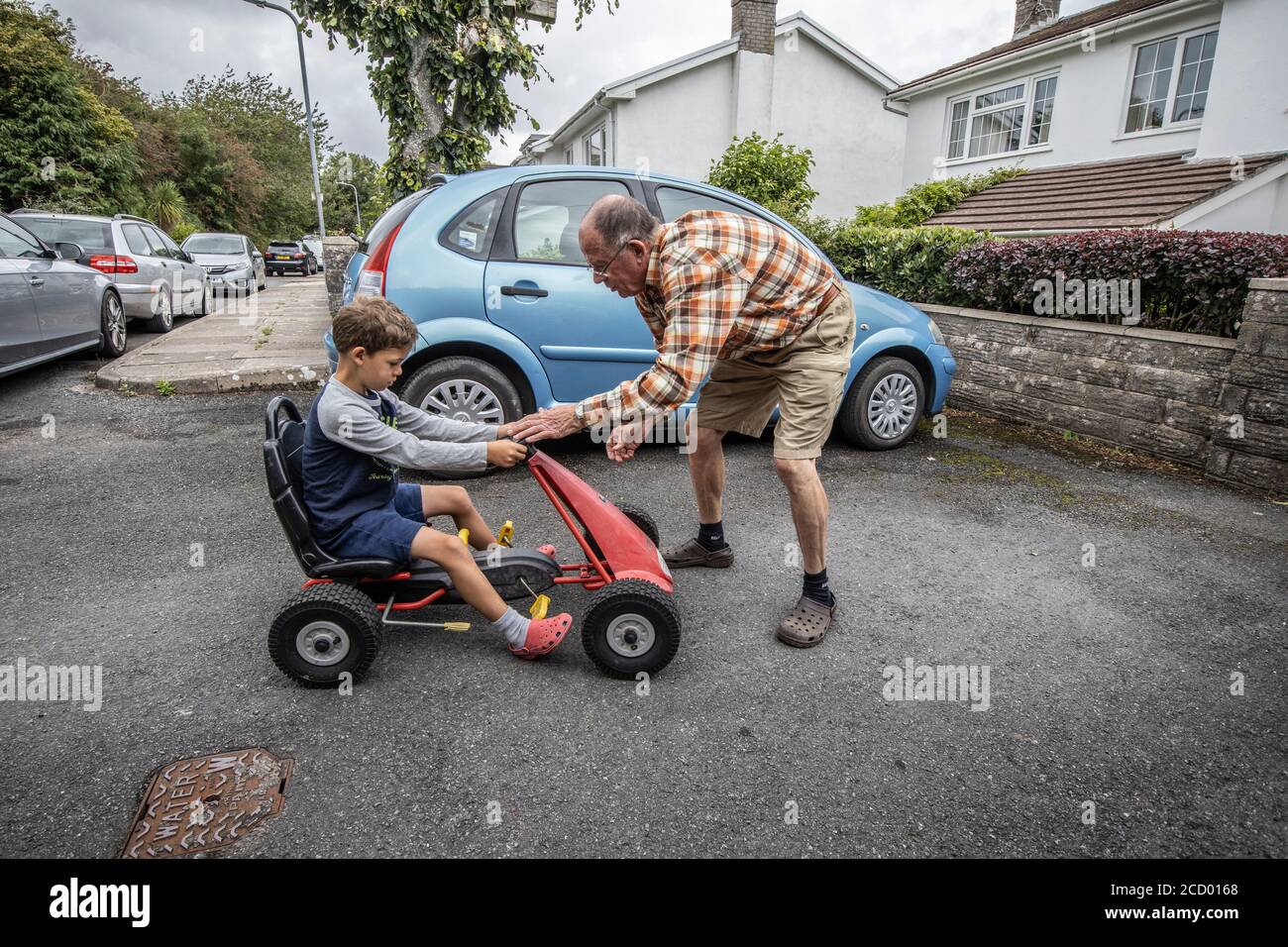 Grandfather at home enjoying the company of his 6 year old grandson, Wales, United Kingdom Stock Photo