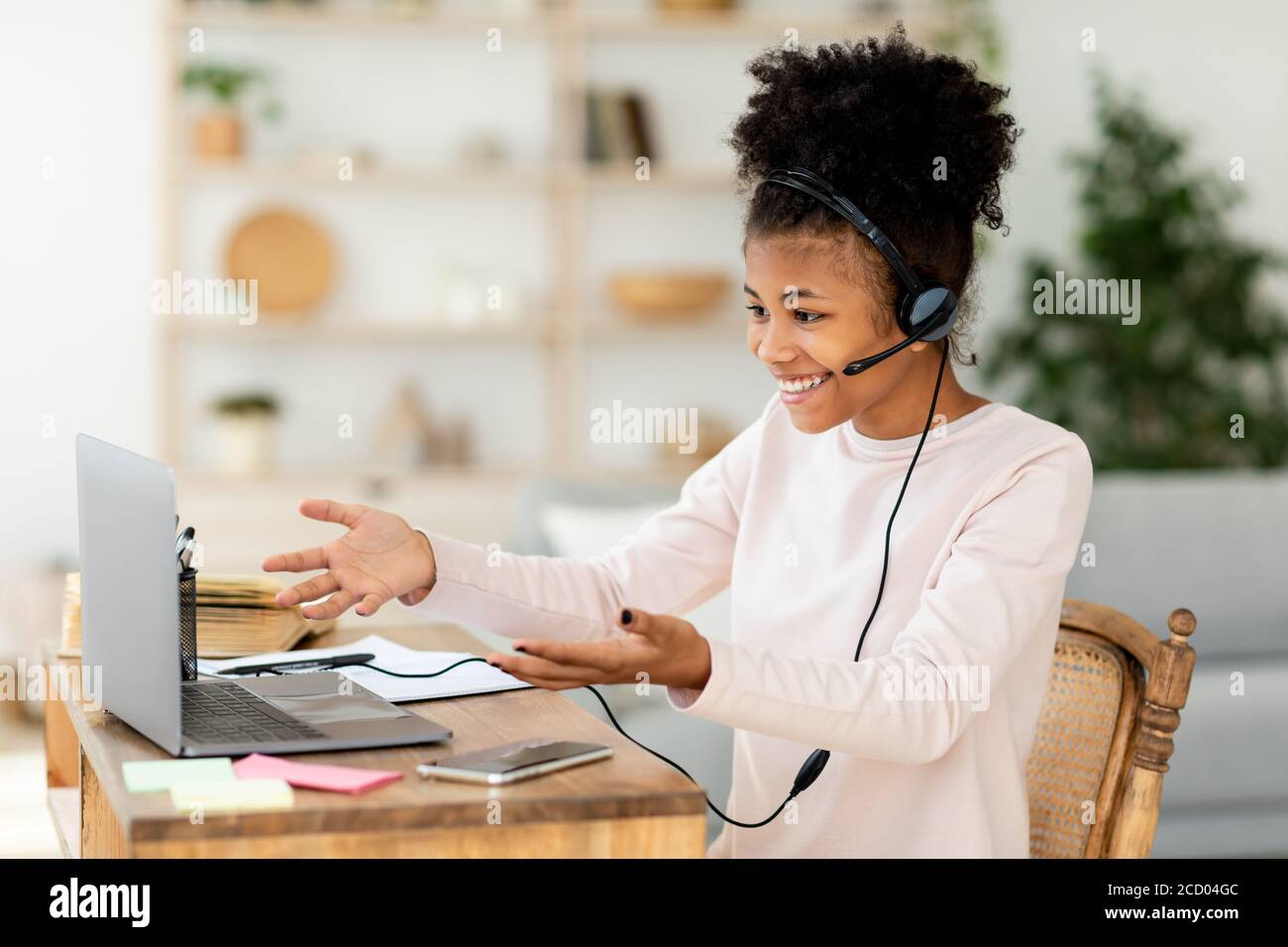 African Teen Girl At Laptop Learning Having Class Sitting Indoors Stock Photo