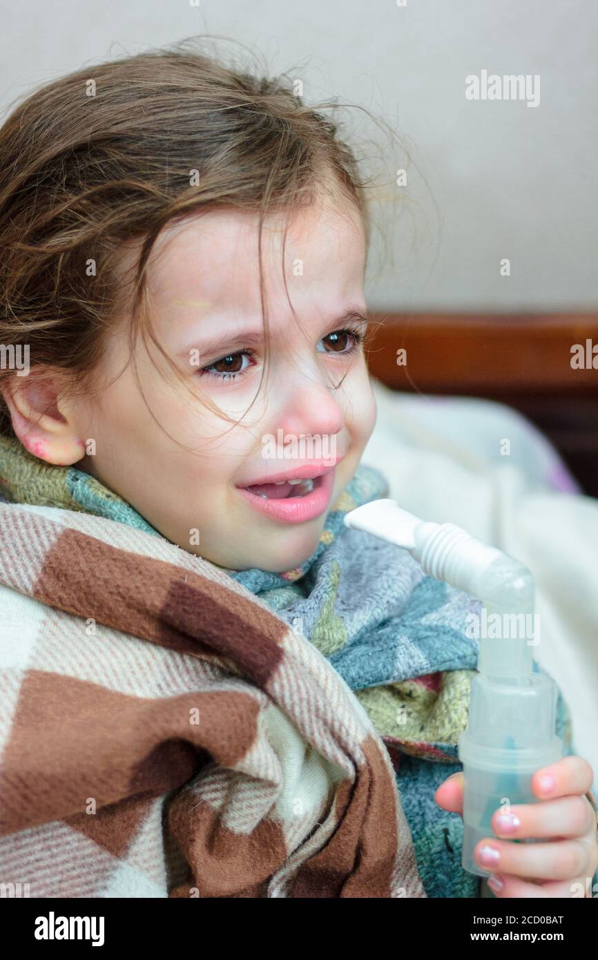 Child with respiratory illness making inhalation with inhaler Stock ...