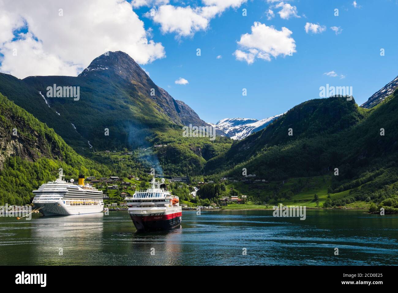 Ocean liner Costa Magica with Hurtigruten cruise ship Polarlys in Geirangerfjorden or Geiranger Fjord. Geiranger, Norway Stock Photo