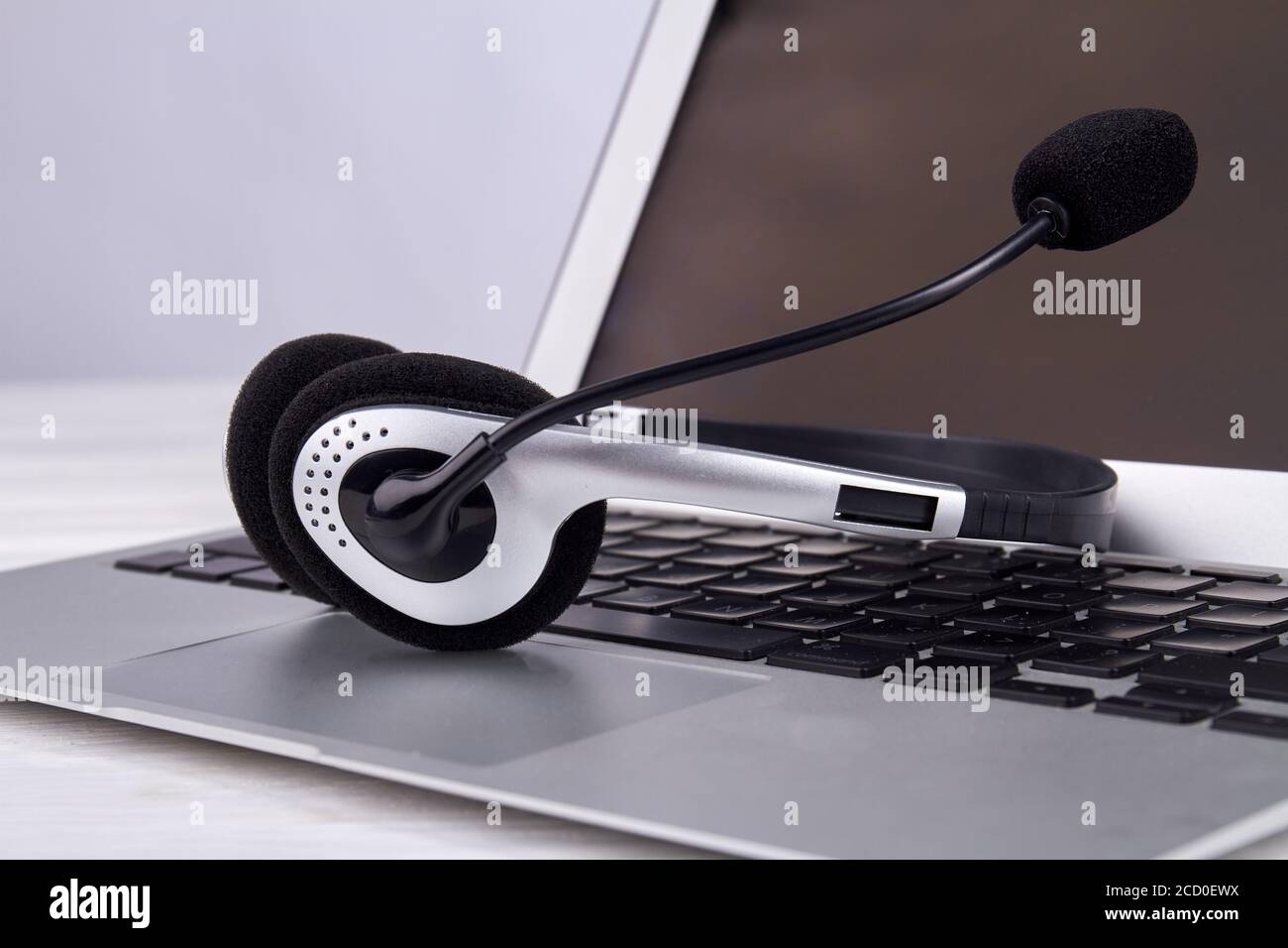 Headset on a laptop keyboard Stock Photo Alamy
