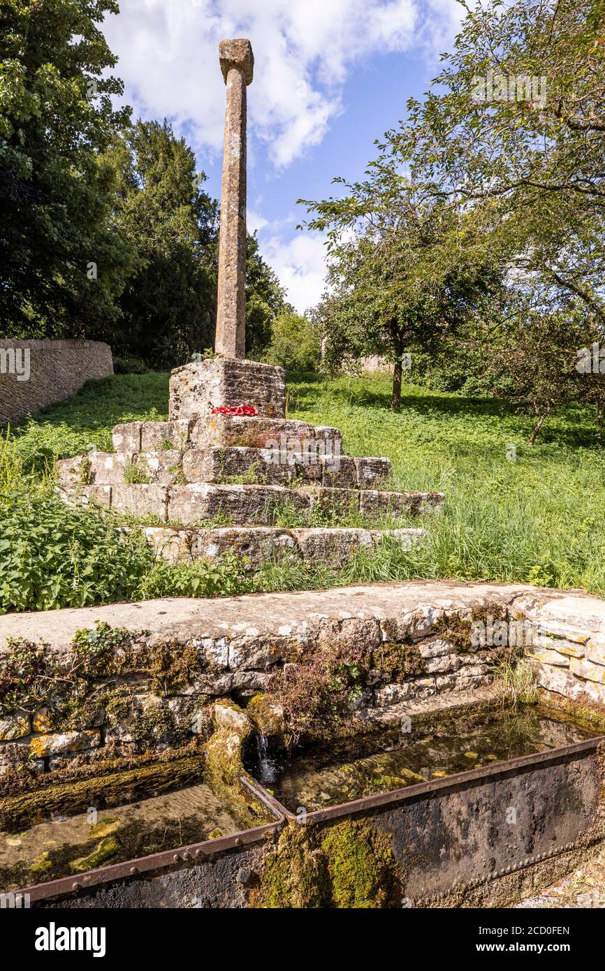 The 14th century wayside cross above the spring in the Cotswold village of Calmsden Gloucestershire UK Stock Photo