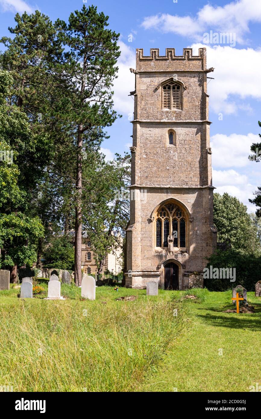 The Church of St John the Evangelist beside Elkstone Manor in the Cotswold village of Elkstone, Gloucestershire UK Stock Photo