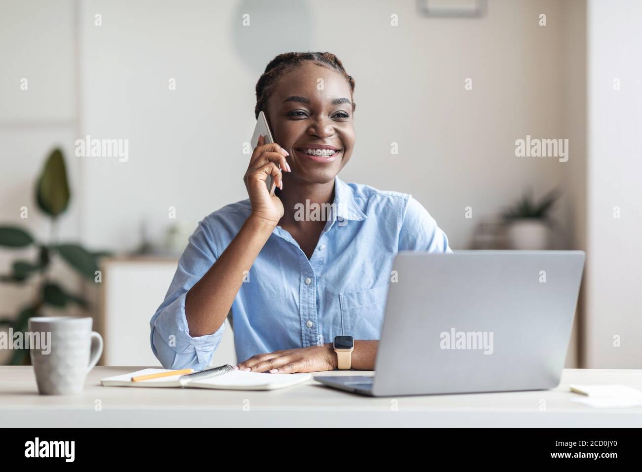 Black female entrepreneur talking on cellphone at workplace in office ...