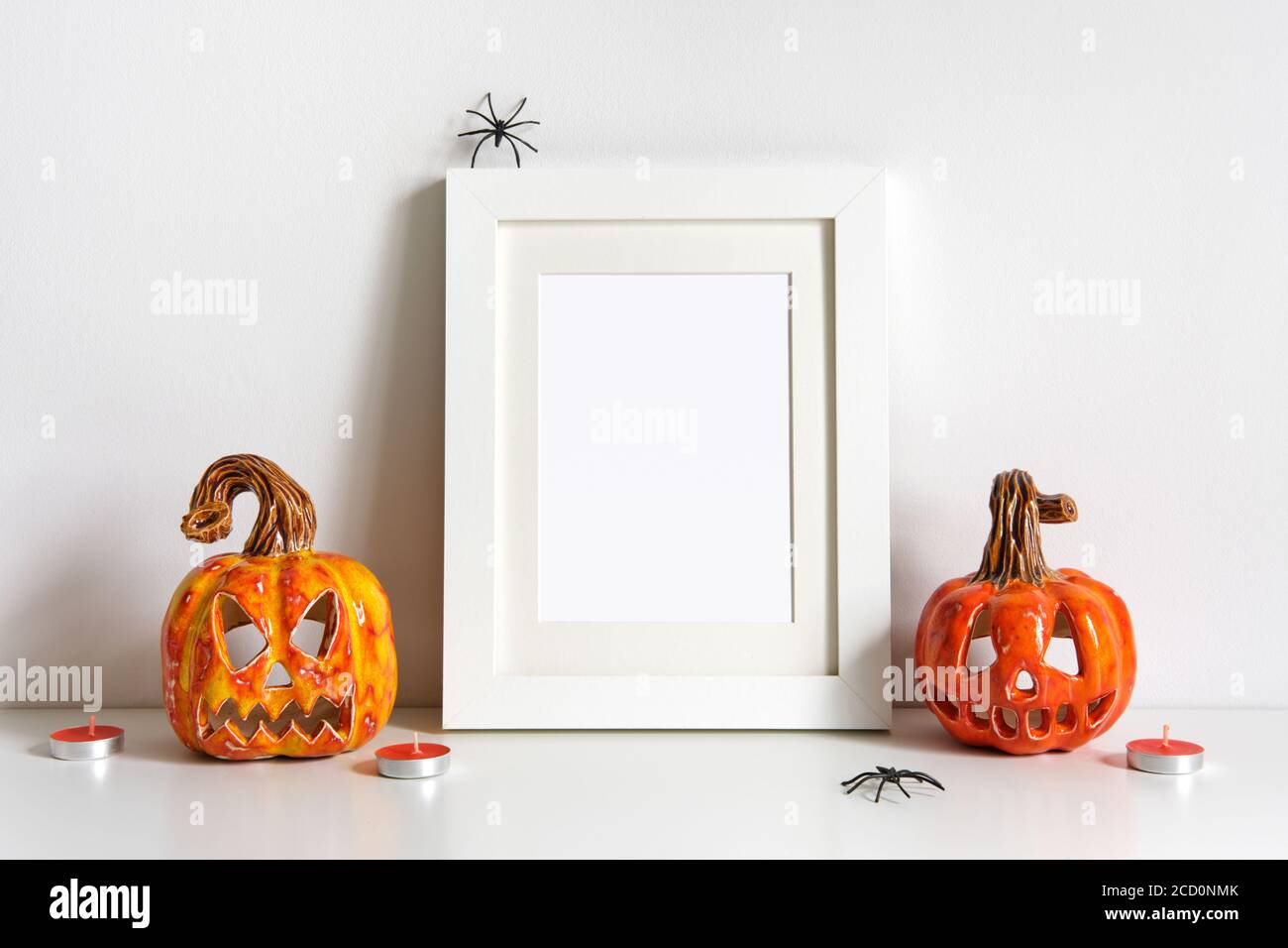 Halloween composition with ceramic pumpkins jack lantern and frame on ...