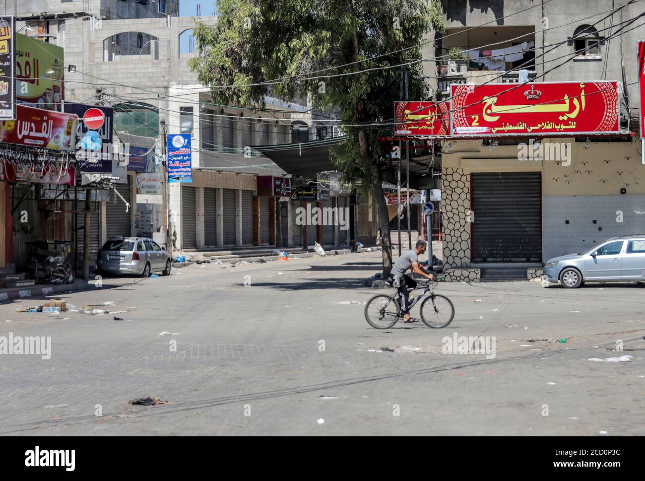 Gaza, Palestine. 25th Aug, 2020. A cyclist rides along a deserted street during the Coronavirus (COVID-19) lockdown .Gaza reported its first cases in the general population as authorities confirmed four infections at a refugee camp and security forces declared a full lockdown for 48 hours. The four cases were from a single family, according to a government statement. The closure would affect the entire Gaza Strip, according to an official from Hamas, the group that governs the territory. Credit: SOPA Images Limited/Alamy Live News Stock Photo