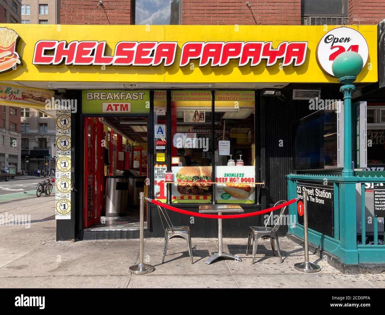 A red velvet rope delineates outdoor dining of the Chelsea Papaya establishment as if waiting for a bouncer to admit a celebrity, seen in Chelsea in New York on Monday, August 17, 2020. (© Frances M. Roberts) Stock Photo