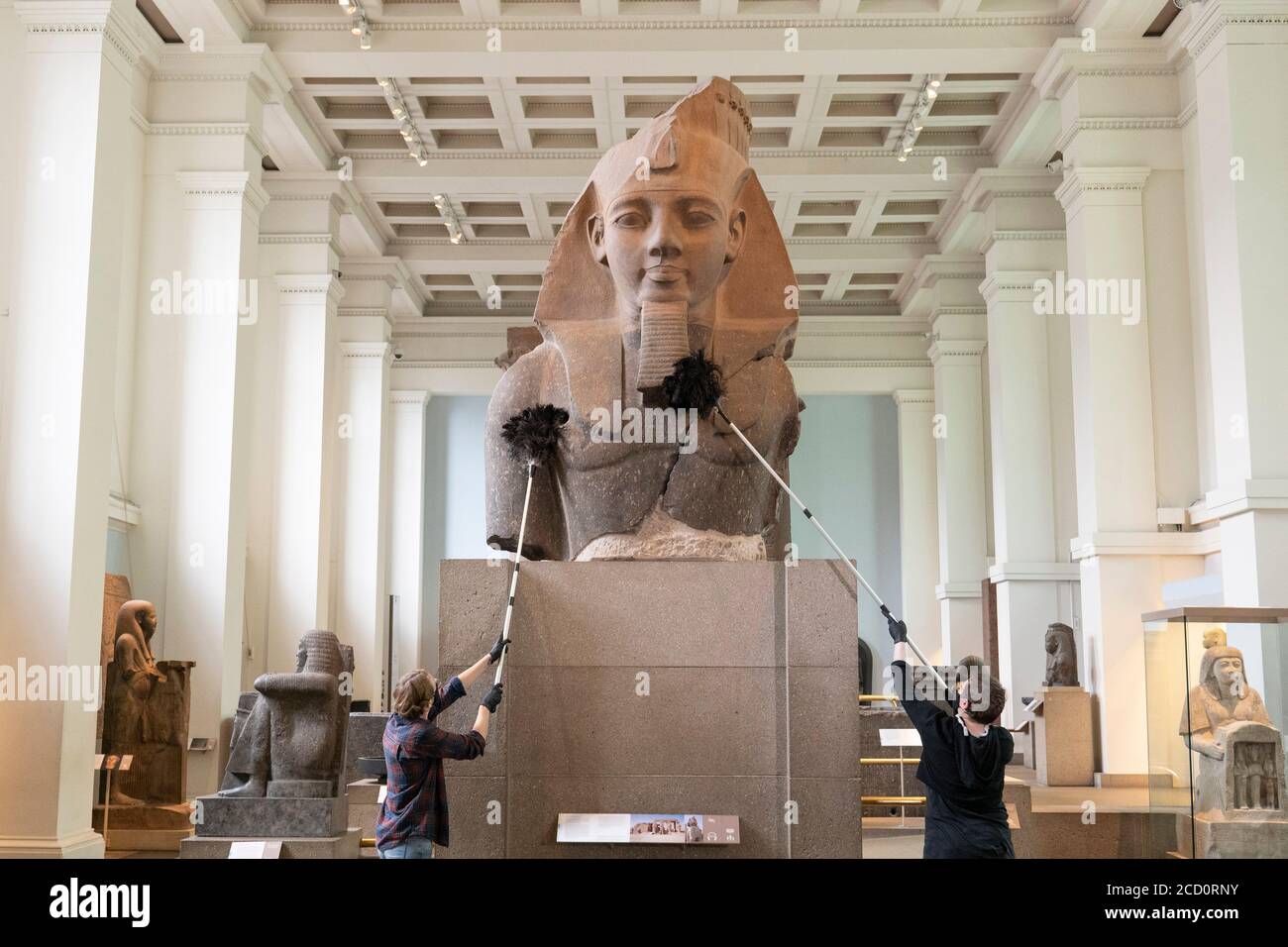 London, England. 25th August 2020. Cleaning staff dust the head of King Ramesses at the British Museum. The British Museum will reopen it’s doors to the public in line with government guidelines and with new safety measures in place. Following five months of closure due to the coronavirus pandemic, the British Museum will be re-opening it’s doors to the public on the 27th August 2020. A new one-way route round the ground floor galleries will allow visitors access to over 9000 objects. More galleries will reopen later in September. (photo by Sam Mellish / Alamy Live News) Stock Photo