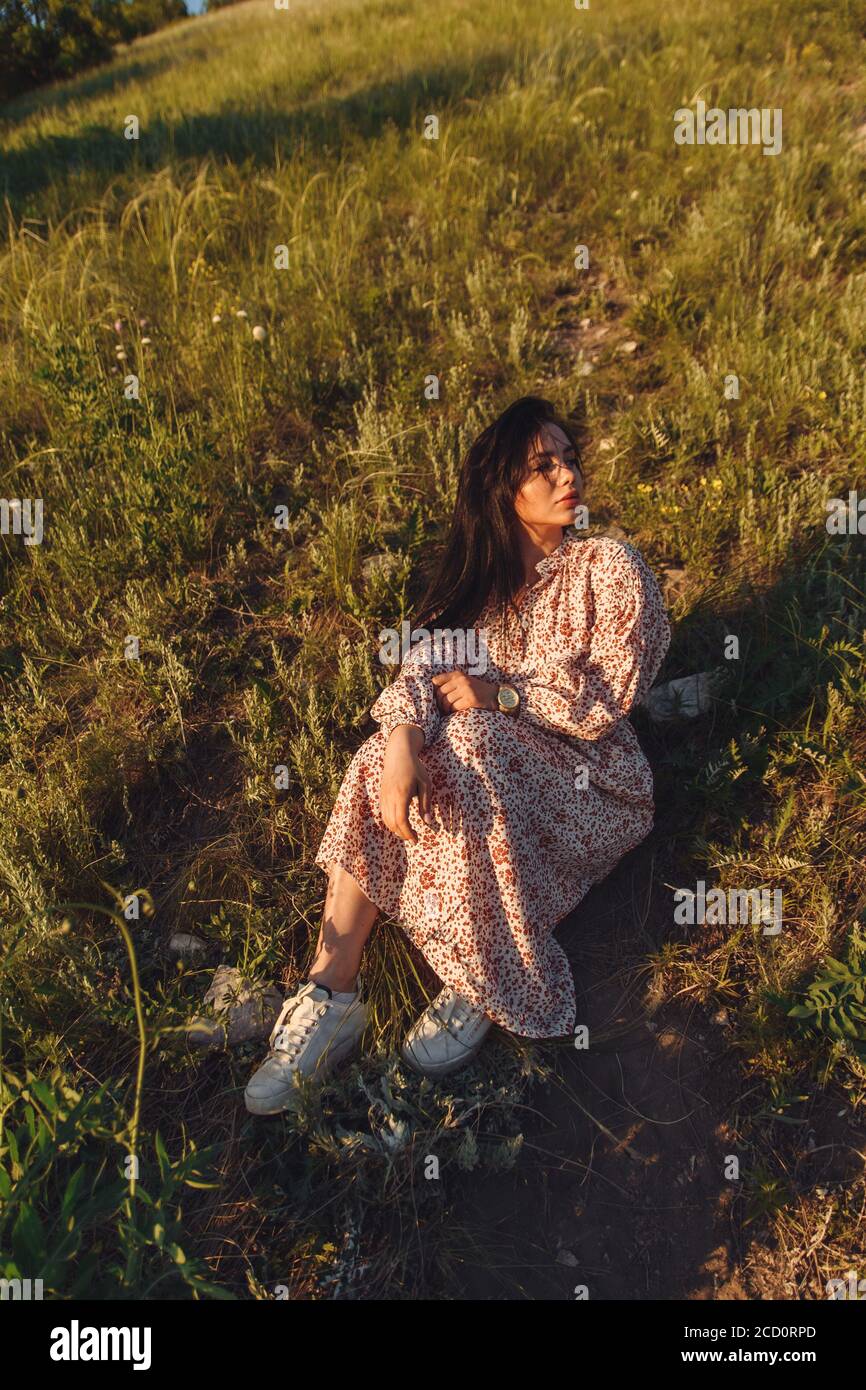 Girl sitting on high hill hi-res stock photography and images - Alamy