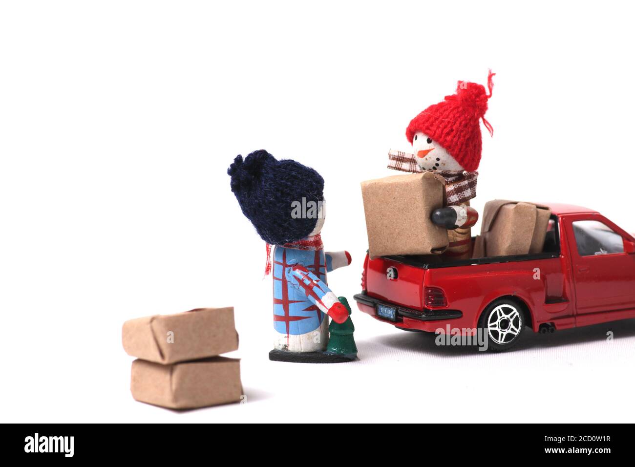snowmen loading wrapped gifts into red pickup isolated on gray ...