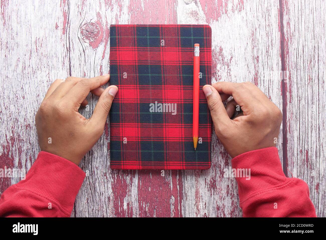 high angle view of notepad and pencil on wooden background  Stock Photo