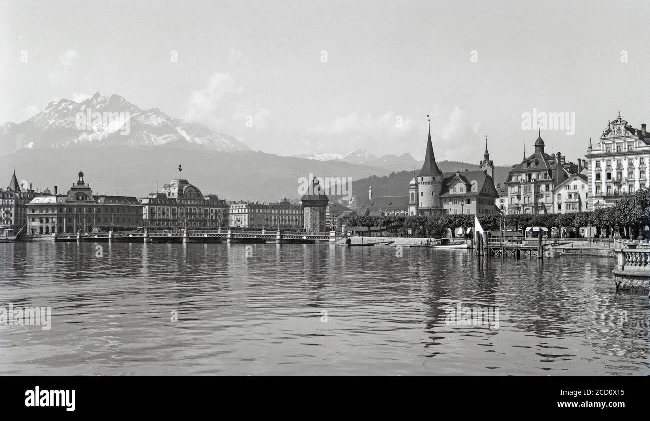 A vintage 1920s black and white photograph showing Lucerne in Switzerland with Mount Pilatus in the background. Stock Photo