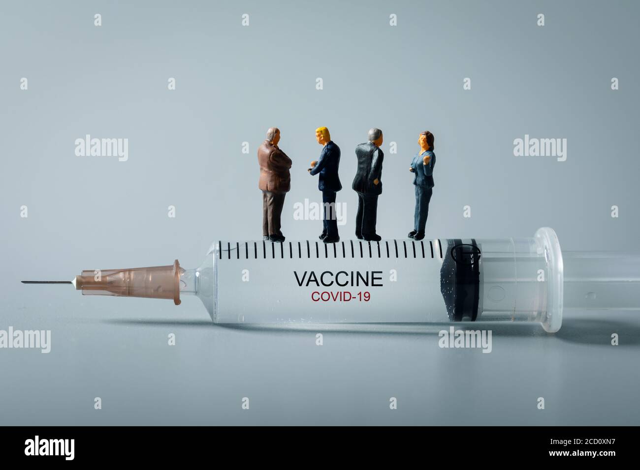 medical industry business people standing on syringe. new covid-19 virus vaccine invention concept Stock Photo