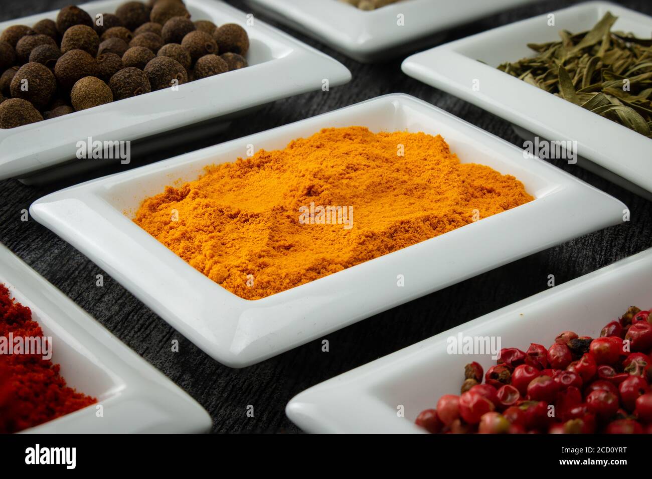 Turmeric powder. Colorful spices in white bowls Seasonings for cooking