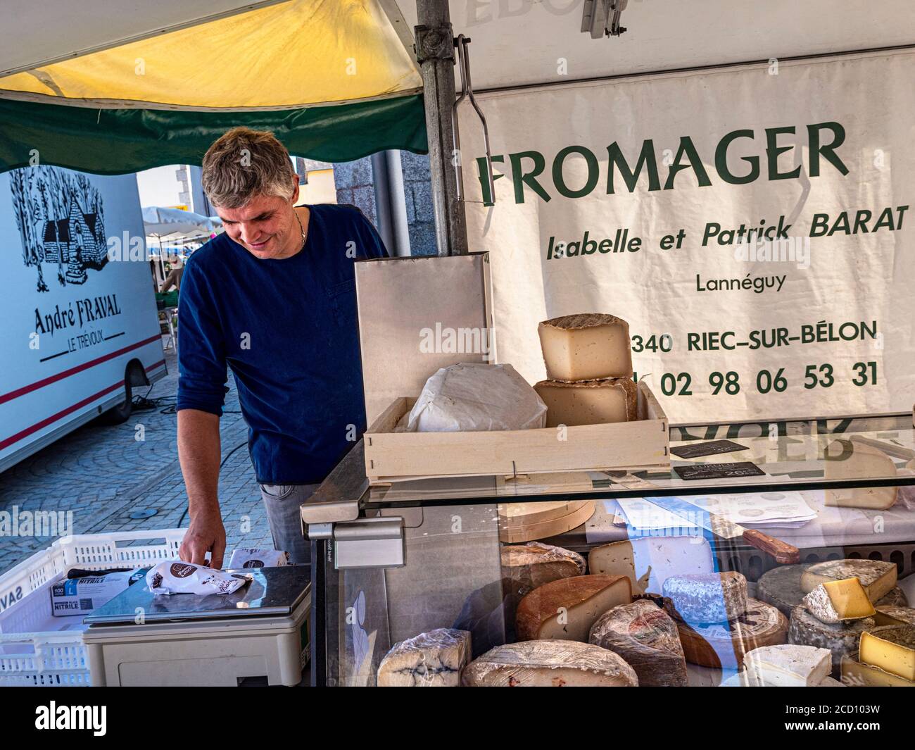 Brittany Cheese market stall Breton Street Market Fromager cheese maker market stall Charming French Breton weekly general market in church square selling local cheeses meats clothing drinks basketware etc in Névez Brittany France Stock Photo