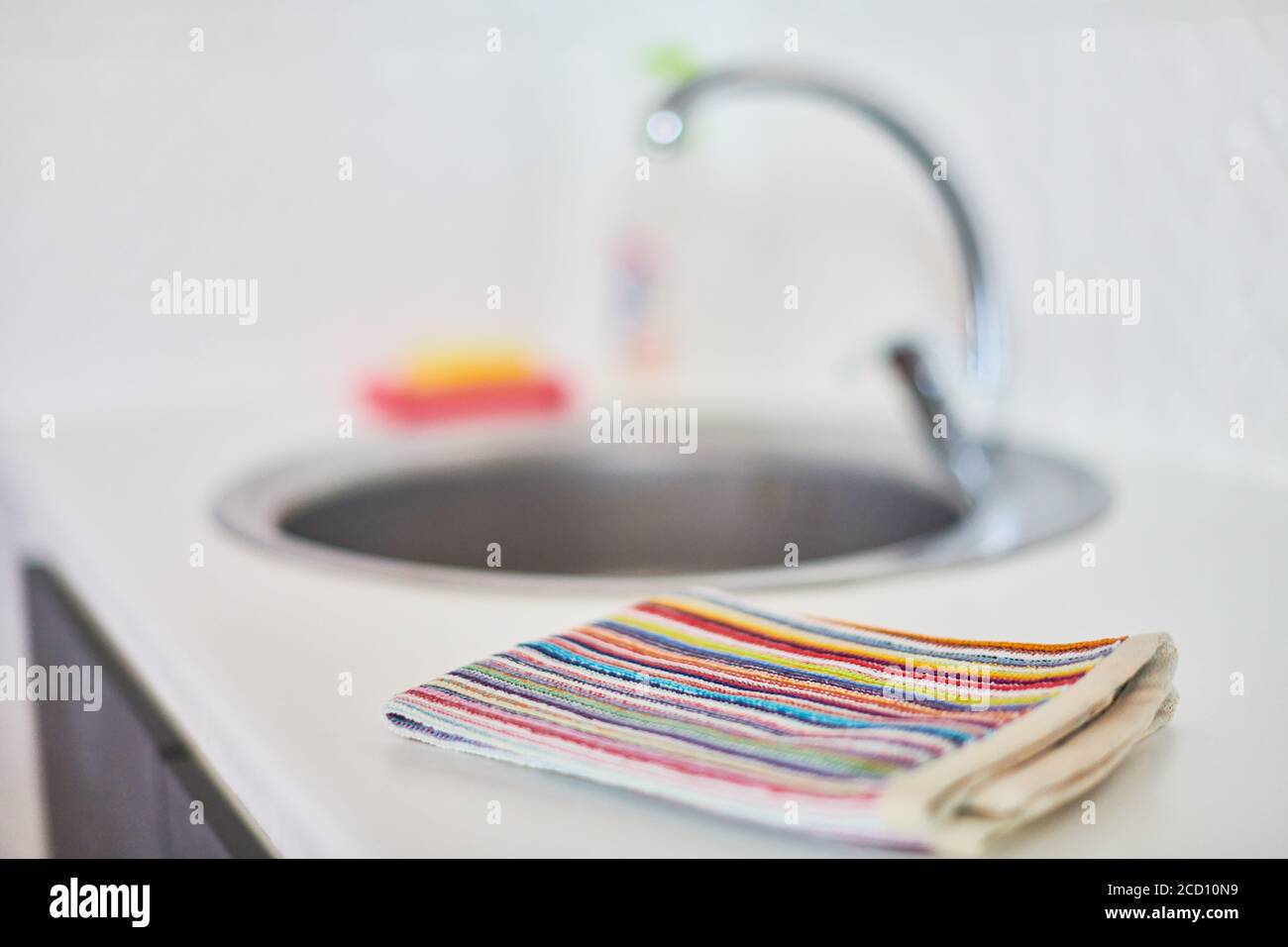 Kitchen towel and sink without dirty dishes background. Dishcloth on