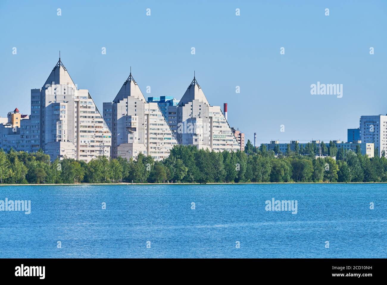 Multistorey pyramid houses view over river. Multistorey high rise