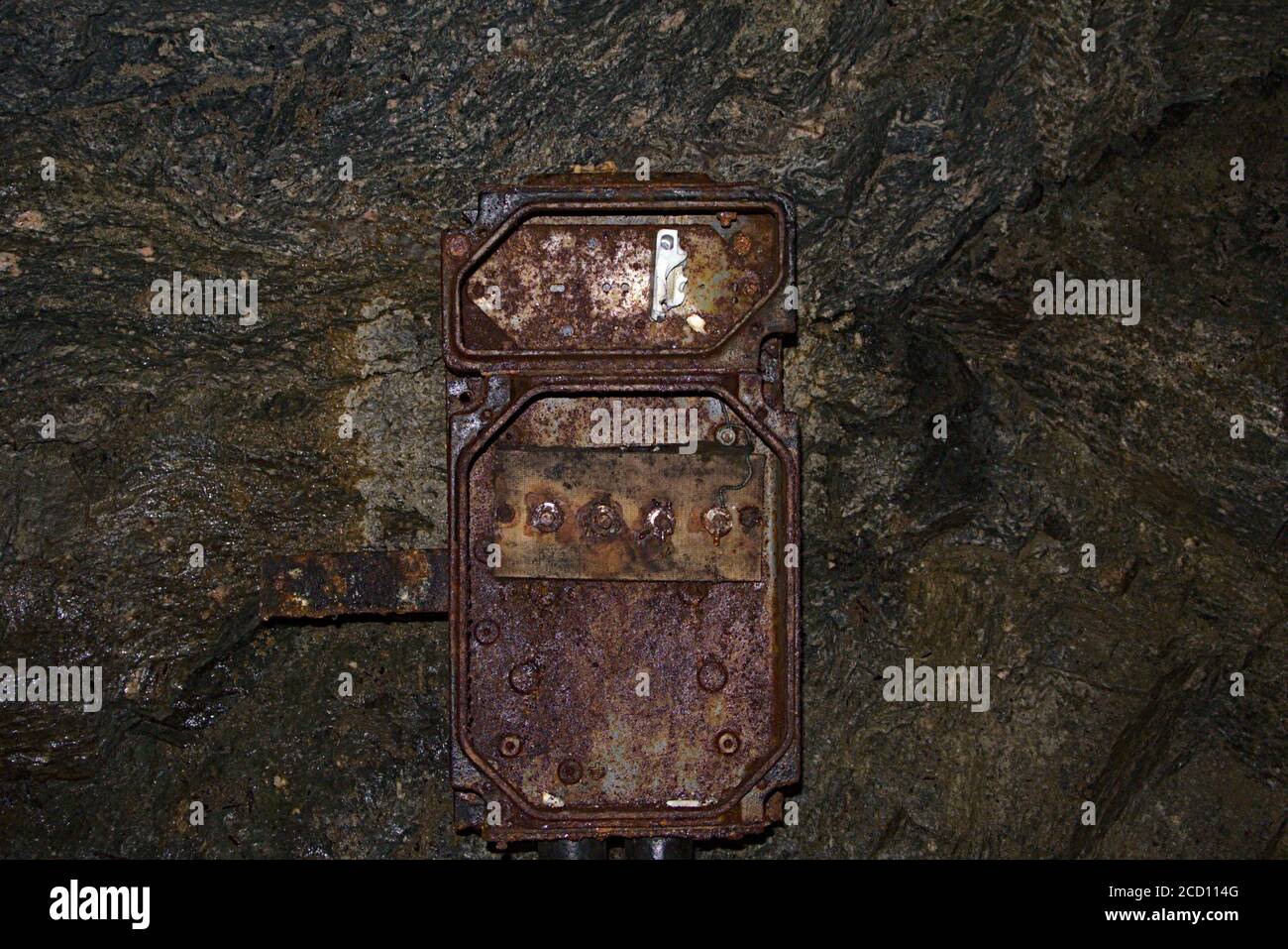 A really old and rusted electric box in an abandoned uranium mine Stock Photo