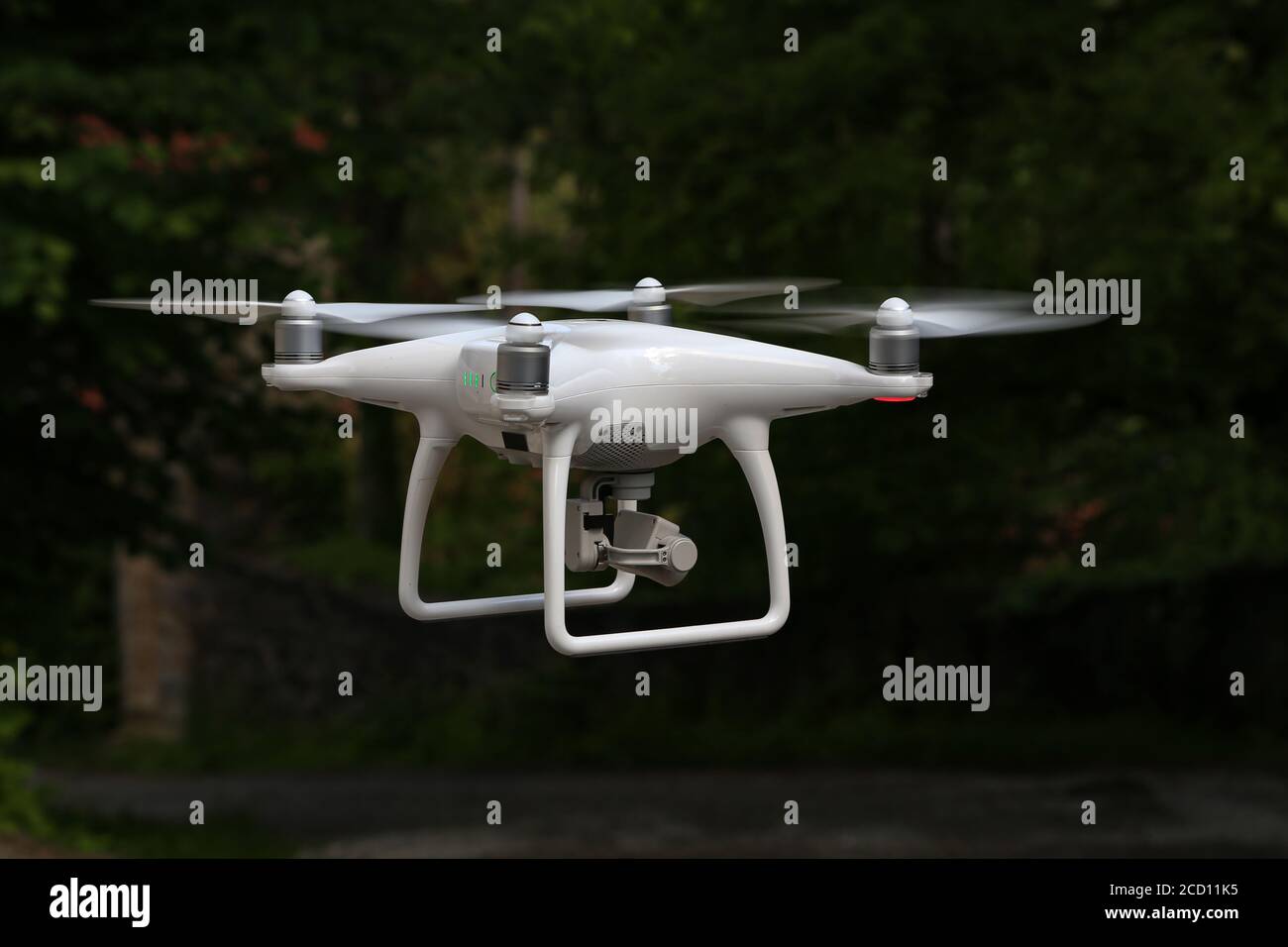 Flying quadcopter with a digital camera on a blurred background Stock Photo