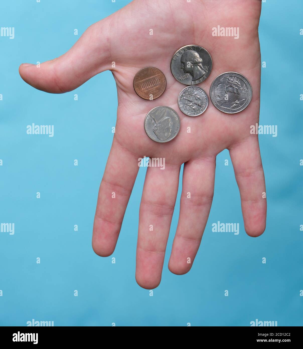 US coins held in palm of hand Stock Photo Alamy