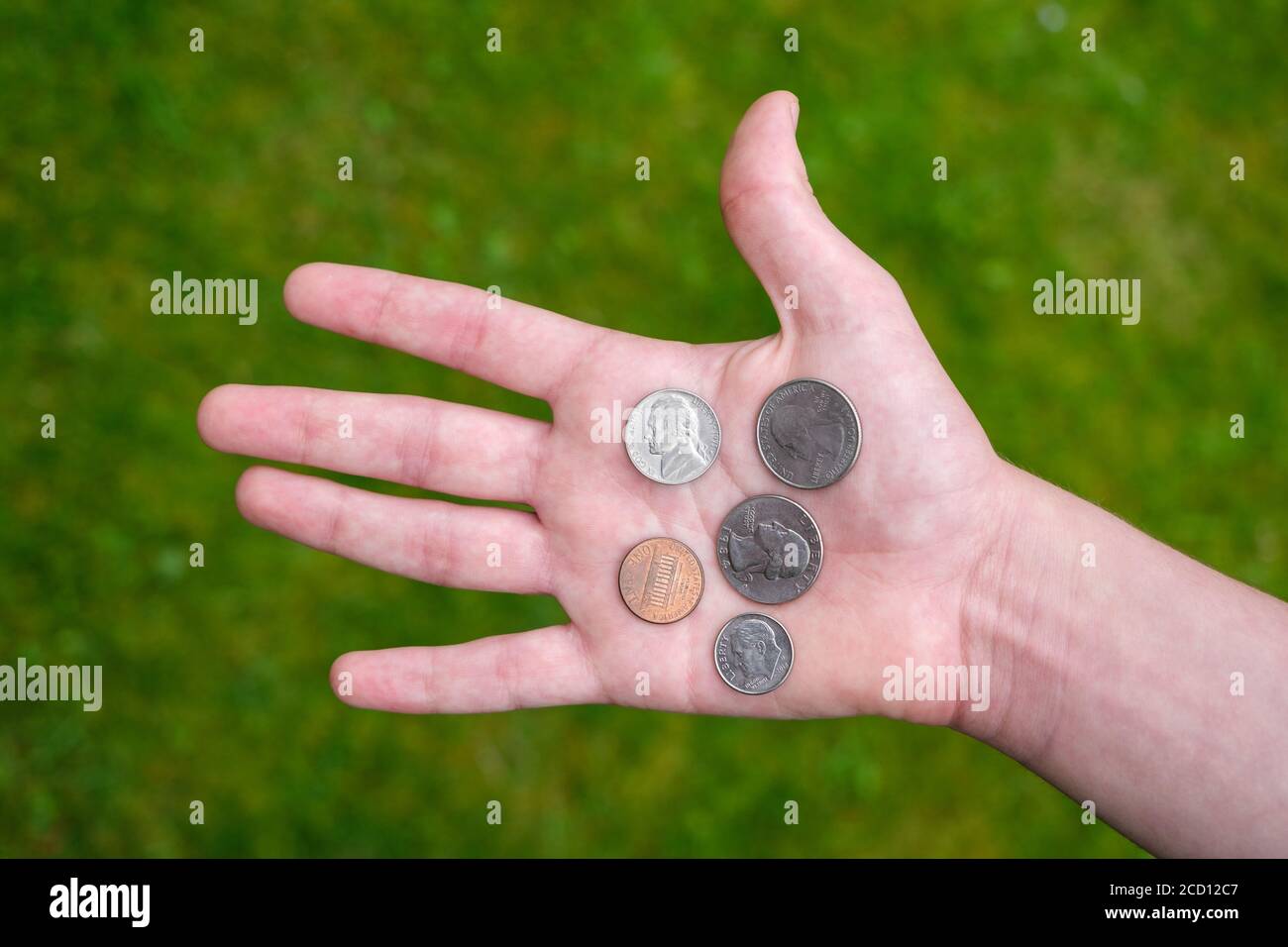 US coins held in palm of hand Stock Photo