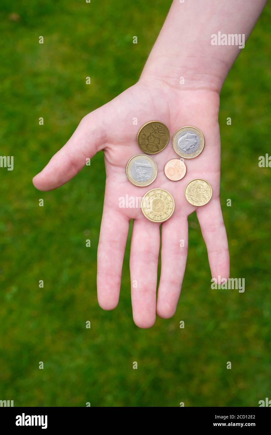 Euro coins held in palm of hand Stock Photo